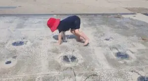 Child playing in water fountain